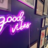 Close up of neon sign reading Good Vibes in script